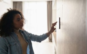 Woman Setting Smart Thermostat