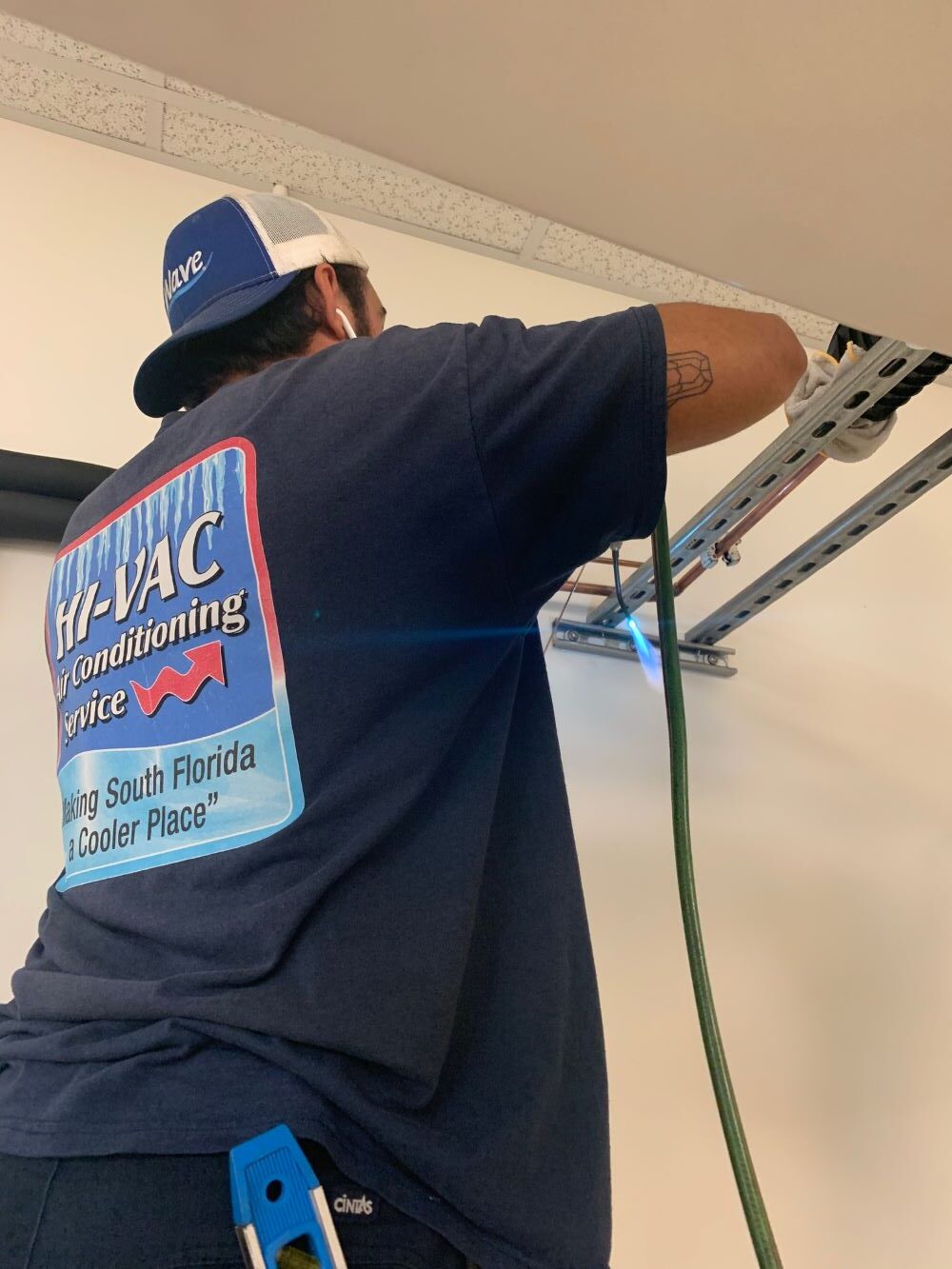 Tech standing behind trane unit